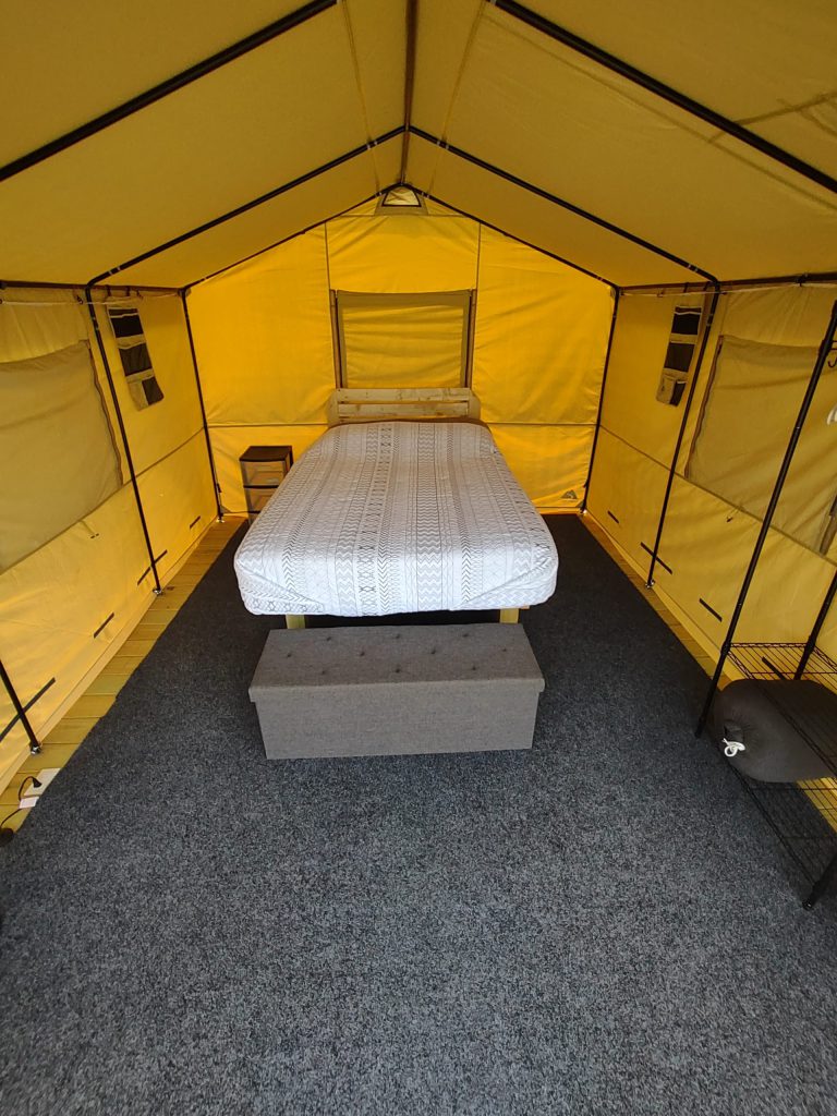 Inside a cabin tent with full size bed